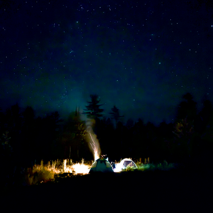 Campfire under a field of stars